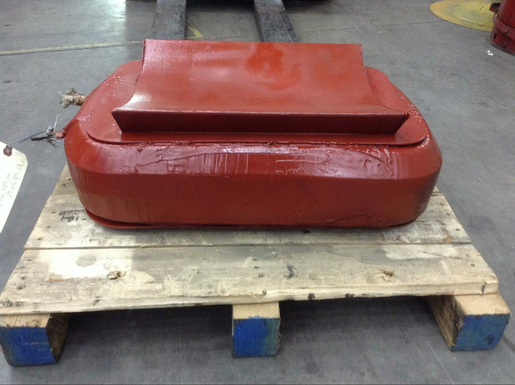 A red dc field coil unit on a pallet after being rewound