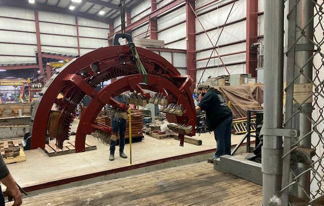 Top half of 3000 KW generator field frame being loaded for delivery.